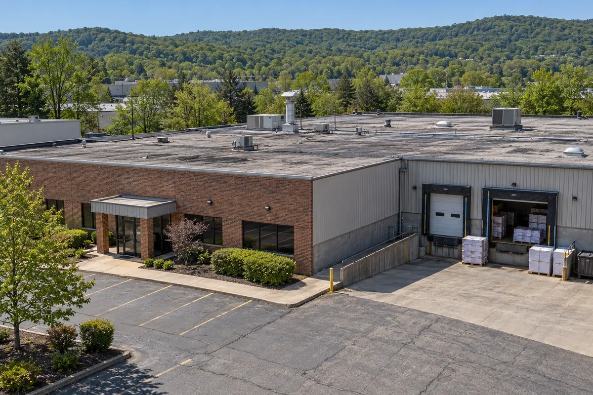 Brick office and warehouse building with a low-slope roof and loading docks